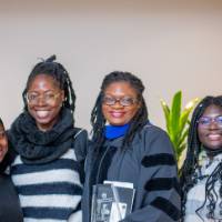 4 women smiling at the ceremony